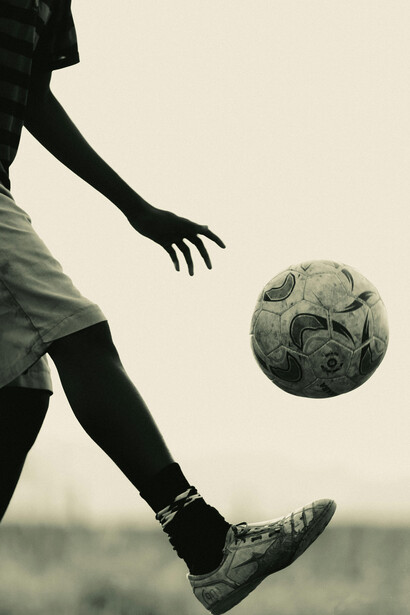 Focused athlete balancing a soccer ball with control