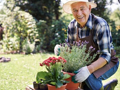 A retired senior man gardening in the field, embracing a peaceful and purposeful life