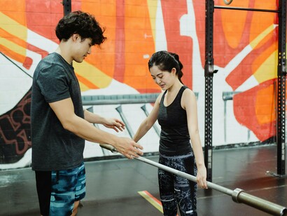 A lady focused on her fitness routine with a partner, symbolising growth that begins with simple steps