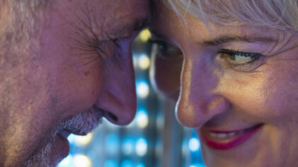 Happy couple sharing a tender moment, looking at each other closely with affection