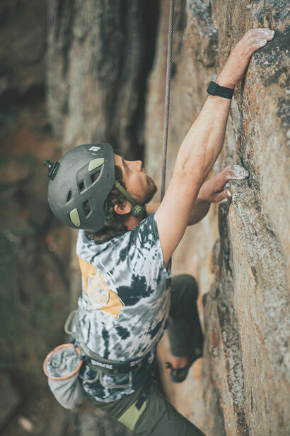Gastonia, North Carolina, USA , a man wearing a helmet climbs a rock face, symbolizing courage and stepping beyond the comfort zone