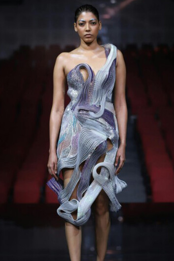 A haute couture model presents designer fashion onstage in India