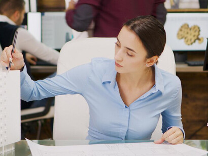 A female architect working with Building Information Modeling (BIM) to design 3D building models, incorporating advanced 3D printing techniques in the construction workflow