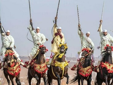 Traditional Moroccan Fantasia horsemen in coordinated motion, representing the discipline and continuity at the heart of Morocco’s diplomatic model