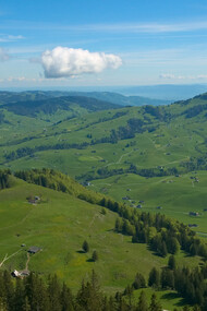 A car of the Luftseilbahn Wasserauen-Ebenalp in front of the landscape around Appenzell, Switzerland