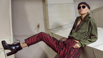 Trendy and confident: a stylish woman in sunglasses reflects themes of feminist art and queer identity