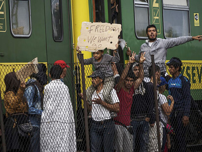 Syrian refugees gather in protest at Budapest’s Keleti railway station amid the refugee crisis on 4 September 2015