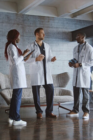 The weight of responsibility hangs in the air as these three doctors connect over shared struggles, each one striving to make a difference despite their own vulnerabilities