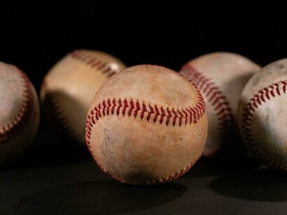 Several baseballs on a surface, depicting how this game can be enjoyed anywhere as long as there is passion