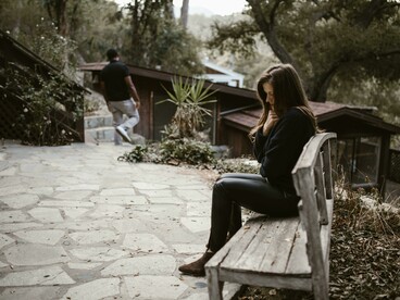 An upset couple faces a breakup, with both partners showing signs of sadness and despair