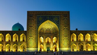 Night view of the Tilya Kori Madrasah in Samarkand, Uzbekistan, famed for its golden interiors and role as both a mosque and madrasa