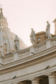 The sculptures adorning the top of St. Peter's Basilica in Italy, notably the colossal statues of saints and angels, stand as majestic symbols of religious devotion and architectural mastery, Vatican