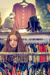 Moça compra roupas em brechó