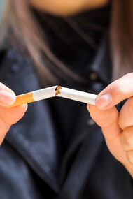 A woman breaking free from the shackles of a harmful smoking habit, embracing a healthier lifestyle and newfound freedom