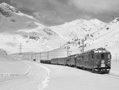 As pessoas ao meu lado seguravam malas com firmeza, como se o peso delas não fosse somente físico. Não se ouviam risos ou conversas — apenas o som do vento e o esporádico tilintar dos sinos anunciando a chegada do próximo trem