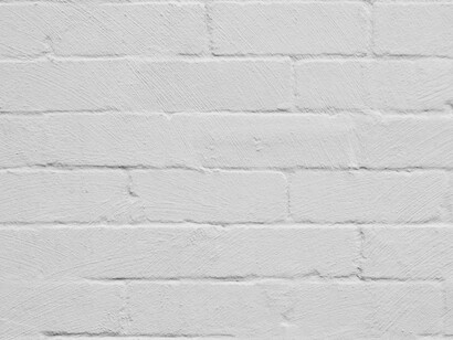 A textured brick wall painted in white