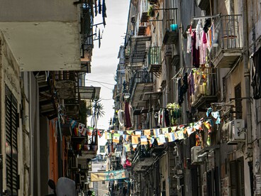 In the heart of Naples, lanterns and flags line the narrow streets of the old town, Italy