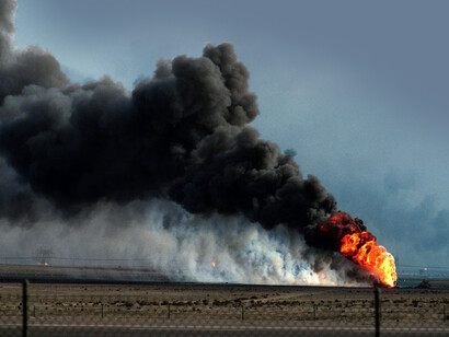 An oil well burns outside Kuwait City after being set ablaze by retreating Iraqi forces during Operation Desert Storm