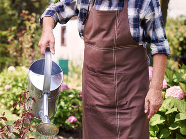 A retired man enjoying his time in the field, gardening as a way to stay active and connected to the land