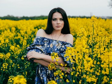 A woman grounded in a field of yellow, symbolising optimism reclaimed after emotional evolution