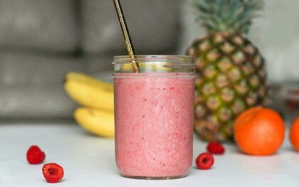 A refreshing smoothie served in a mason jar with a straw