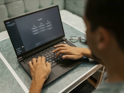 Edge AI concept: a man working on his laptop as AI processes directly on the device