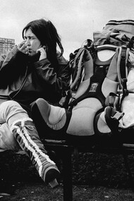 The woman pauses for a moment on a bench, reflecting on the deep connections she’s made during her solo travels to every corner of the globe