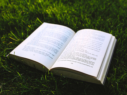 An open book on grass, showing how the tales passed down through the ages help us stay rooted in who we are