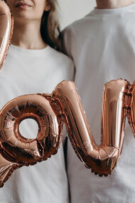 Love sign adorned with heart-shaped balloons