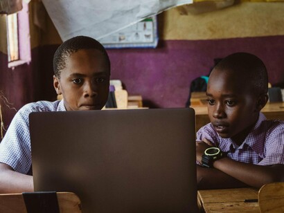 Two African schoolchildren studying together in a classroom, representing the role of education in shaping identity