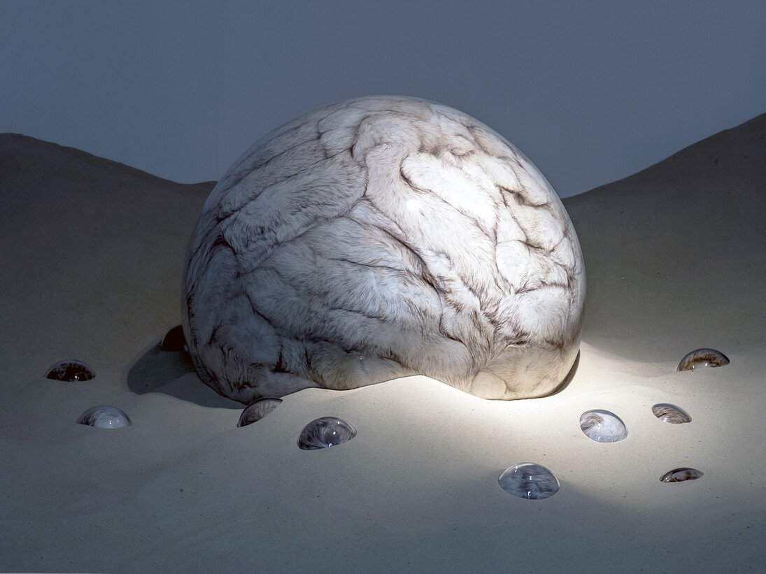 Adeline de Monseignat, Mother HEB Loleta, 2012, Vintage Fur, pillow filler, glass, motor, wood on 2 tonnes of sand, Variable  installation, Courtesy the artist and Ronchini Gallery