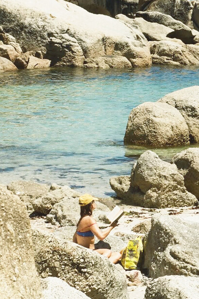 Reading in the sun, Saunders Rock Tidal Pool, Sea Point, Cape Town, photographed by Samantha Caitlin