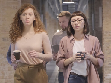 As colleagues walk and chat, they exemplify the power of positive relationships in driving success and well-being