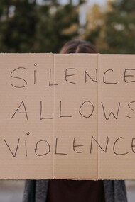 A sign pleading to speak up against injustice