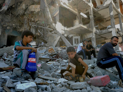 Palestinians search the rubble of their homes destroyed by Israeli strikes in the northern Gaza Strip