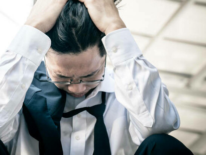 An adult facing anxiety and depression battles feelings of sadness, loneliness, and worry, compounded by experiences of racism and discrimination