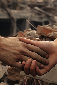 Two people holding hands after earthquake, designed by freepik
