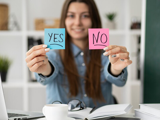 A blurry image of a woman holding Post-it notes — yes or no?