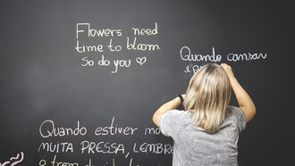 A student writing on the chalkboard