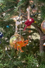 Ornaments hanging off a tree at the gallery in Hudson Beach Glass