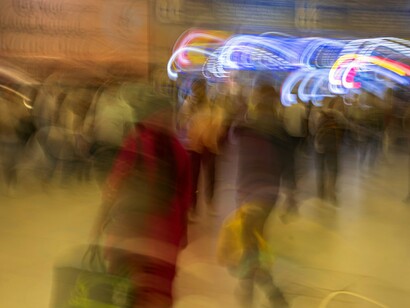 Faces dissolve as individuality is absorbed into the flow of information