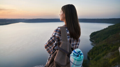 A traveler pauses to soak in stillness, embracing the essence of slow travel 