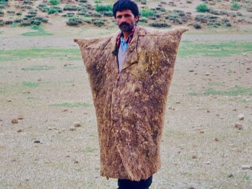 L'immagine ritrae un pastore nomade con il suo gregge presso il lago prosciugato Göper Göl, nella caldera del Nemrut Dağı, mentre indossa il suo speciale «cappotto invernale» per proteggersi dal freddo che spesso regna in alta quota. Foto di Volker Höhfeld