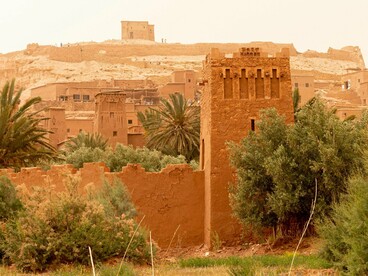 The historic ksar of Ait Ben Haddou rising from arid terrain, symbolising the Kingdom’s enduring relationship between environment and ambition