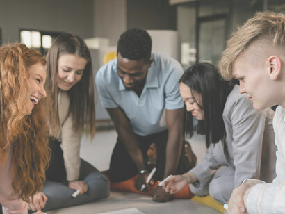 Young professionals from diverse backgrounds engage in a lively brainstorming session, sharing ideas and challenging each other’s viewpoints