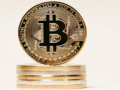 The shiny coin symbolizes how cryptocurrency outshines traditional finance as a borderless option for exchange