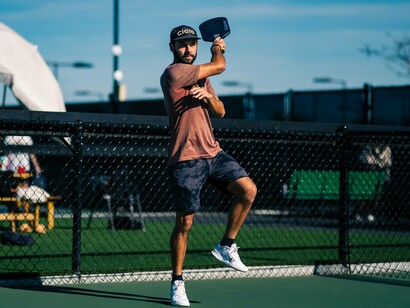 In the heat of the match, this pickleball enthusiast showcases skillful footwork, reflecting the sport’s blend of fitness, strategy, and social connection