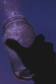 A person releasing stardust onto the night sky