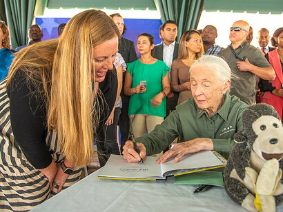 During her visit to the United States Mission in Uganda on April 4, 2022, Jane Goodall signs a document, marking the occasion with her signature