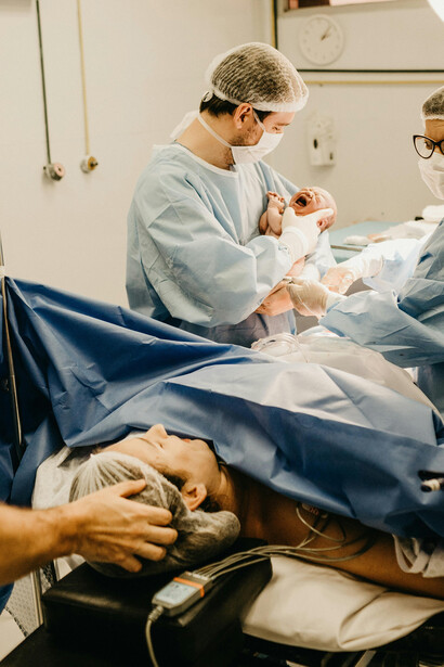 A woman embraces her newborn baby moments after childbirth